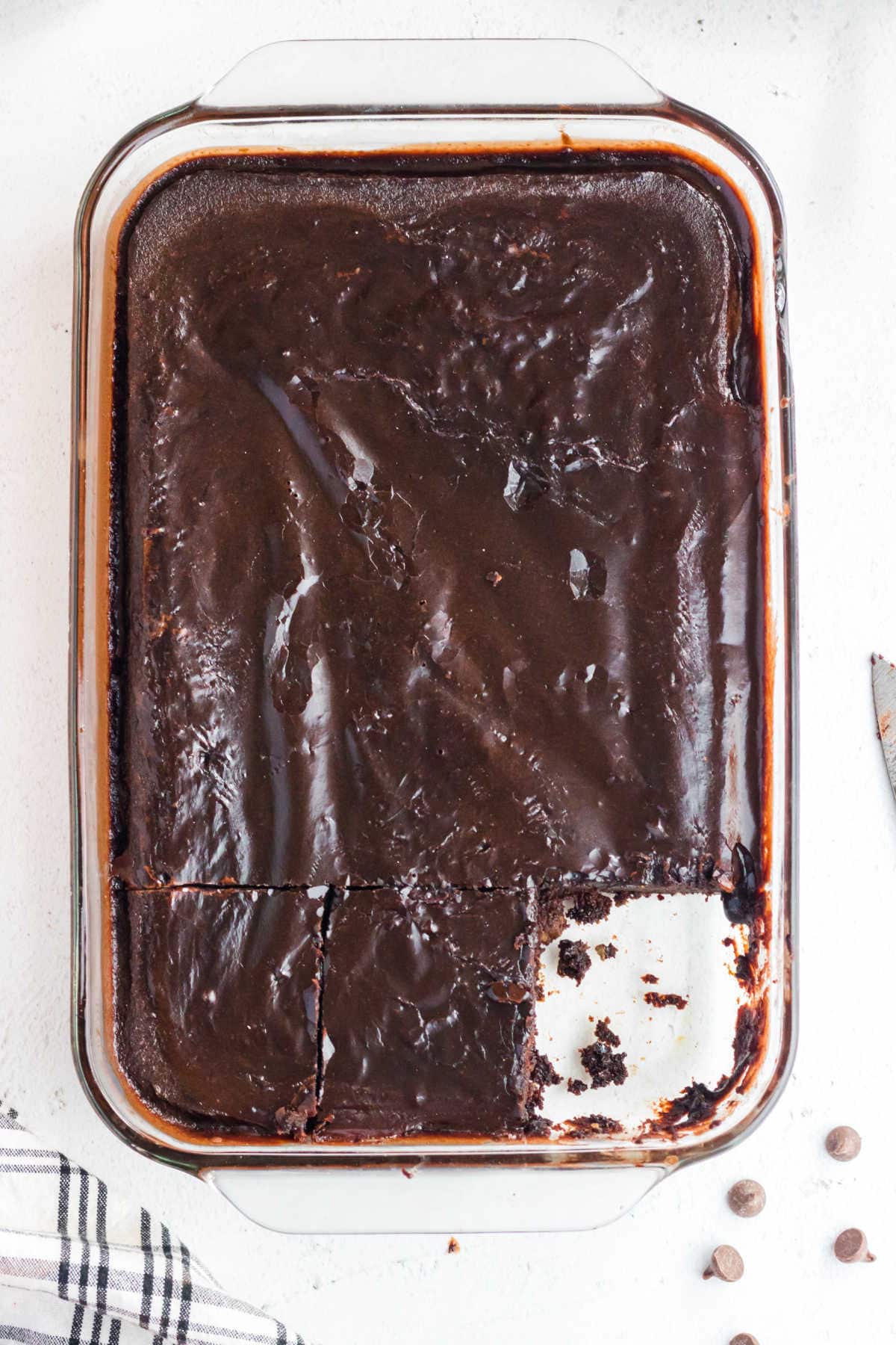 Overhead view of chocolate cake with a serving removed.