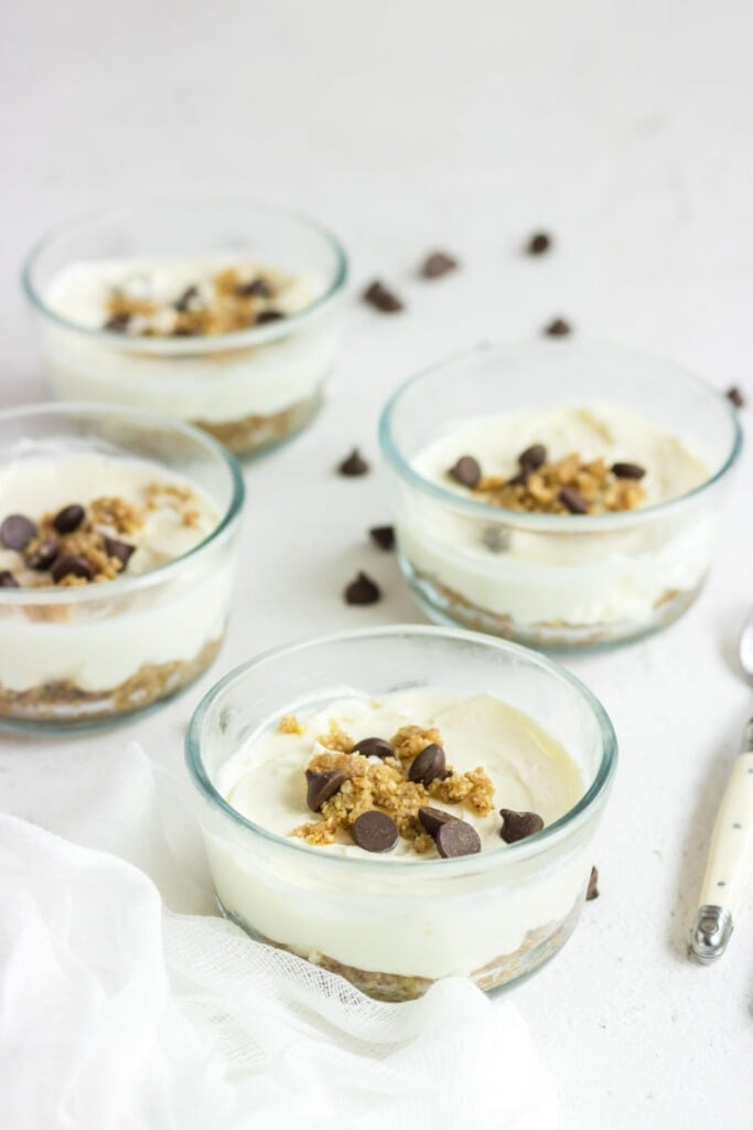 Four bowls of low carb cheesecake with chocolate chips on top.