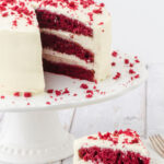 Red velvet cake with a slice removed and text overlay for Pinterest.
