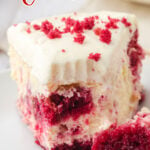 Slice of red velvet cheesecake with a bite taken out and text overlay for Pinterest.