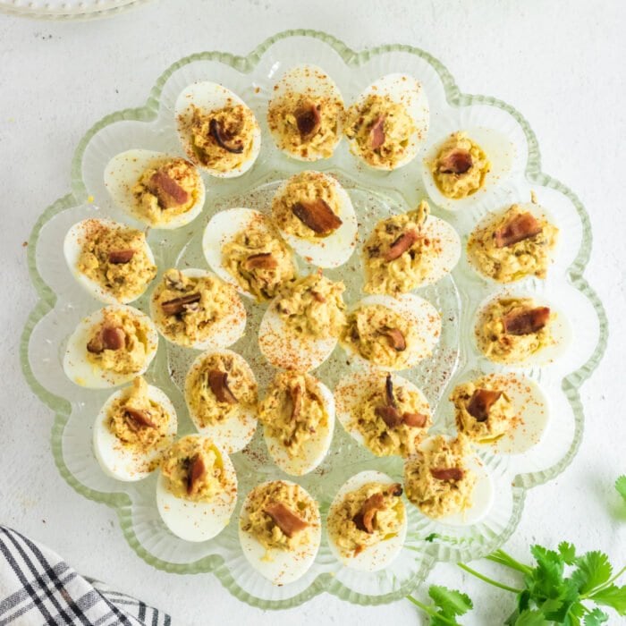 Overhead view of smoked deviled eggs with chipotle and bacon.