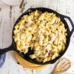 Overhead view of sausage Alfredo skillet dinner in a cast iron skillet.