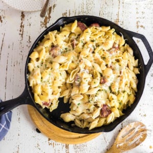 Overhead view of sausage Alfredo skillet dinner in a cast iron skillet.