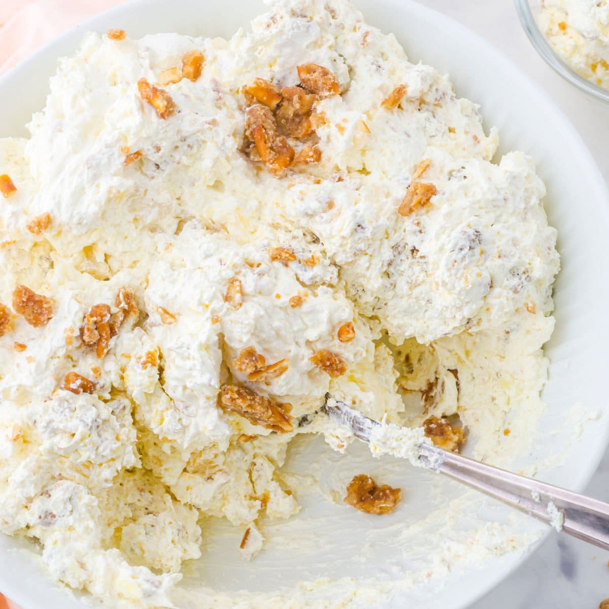 Overhead view of pineapple fluff in a white bowl