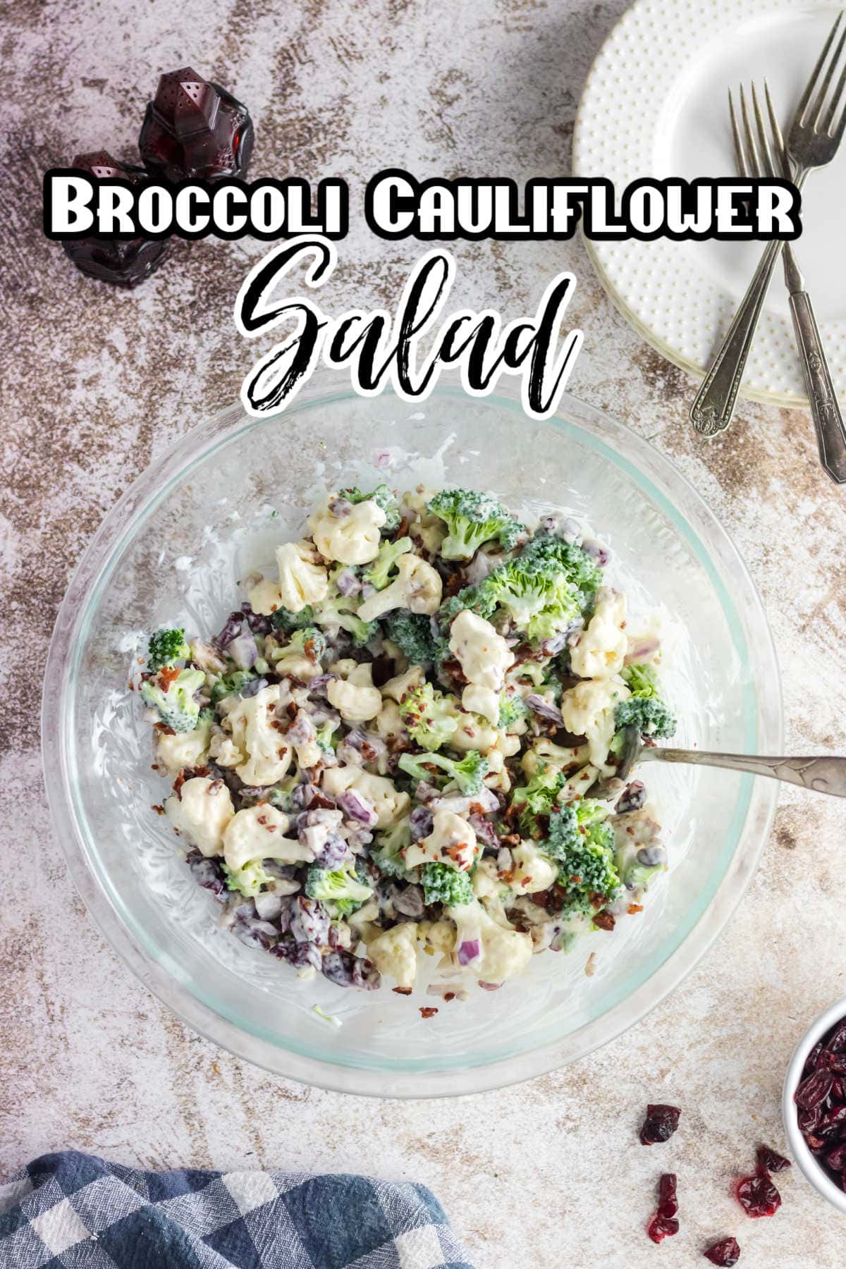 Overhead view of a bowl of broccoli cauliflower salad with a text overlay.