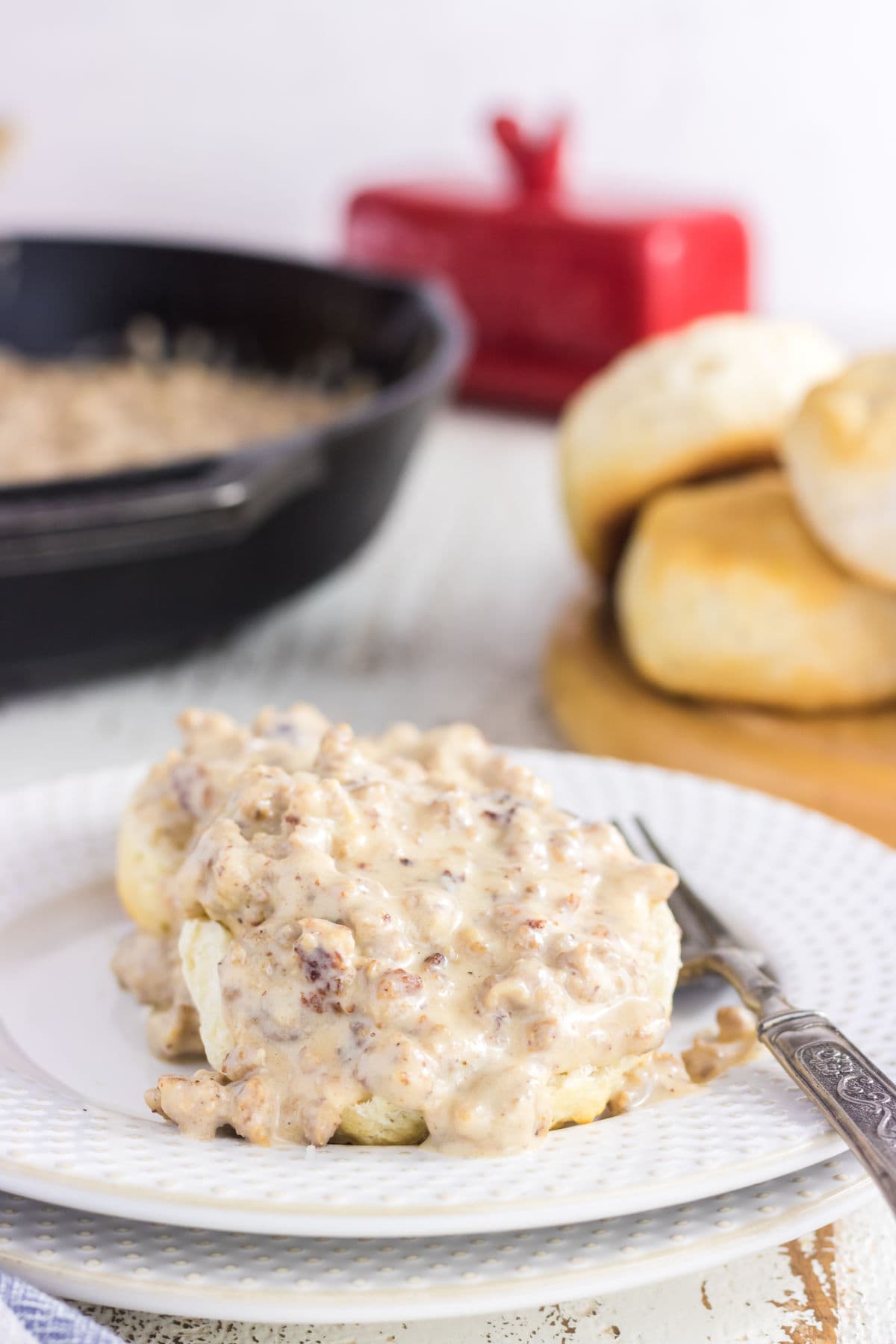 Closeup of biscuits with gravy on top.