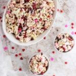 Bowl of white and pink chocolate covered popcorn.