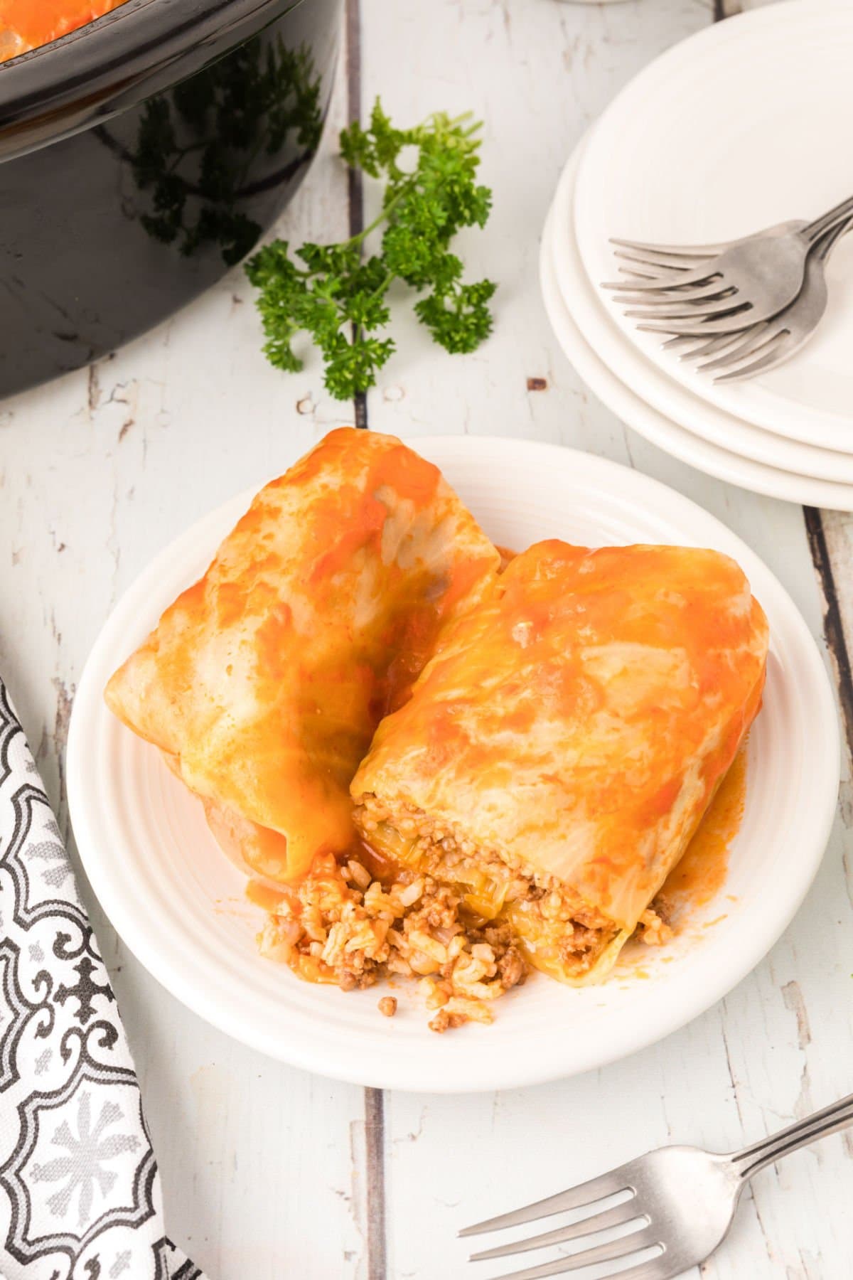 Cut cabbage rolls on a plate showing the filling.