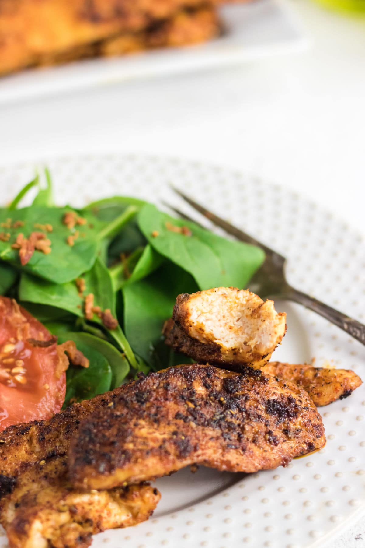 Closeup of chicken showing the spicy exterior and juicy interier.