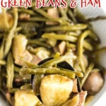Crockpot green beans, ham, and potatoes in a serving dish with text overlay for pinterest.
