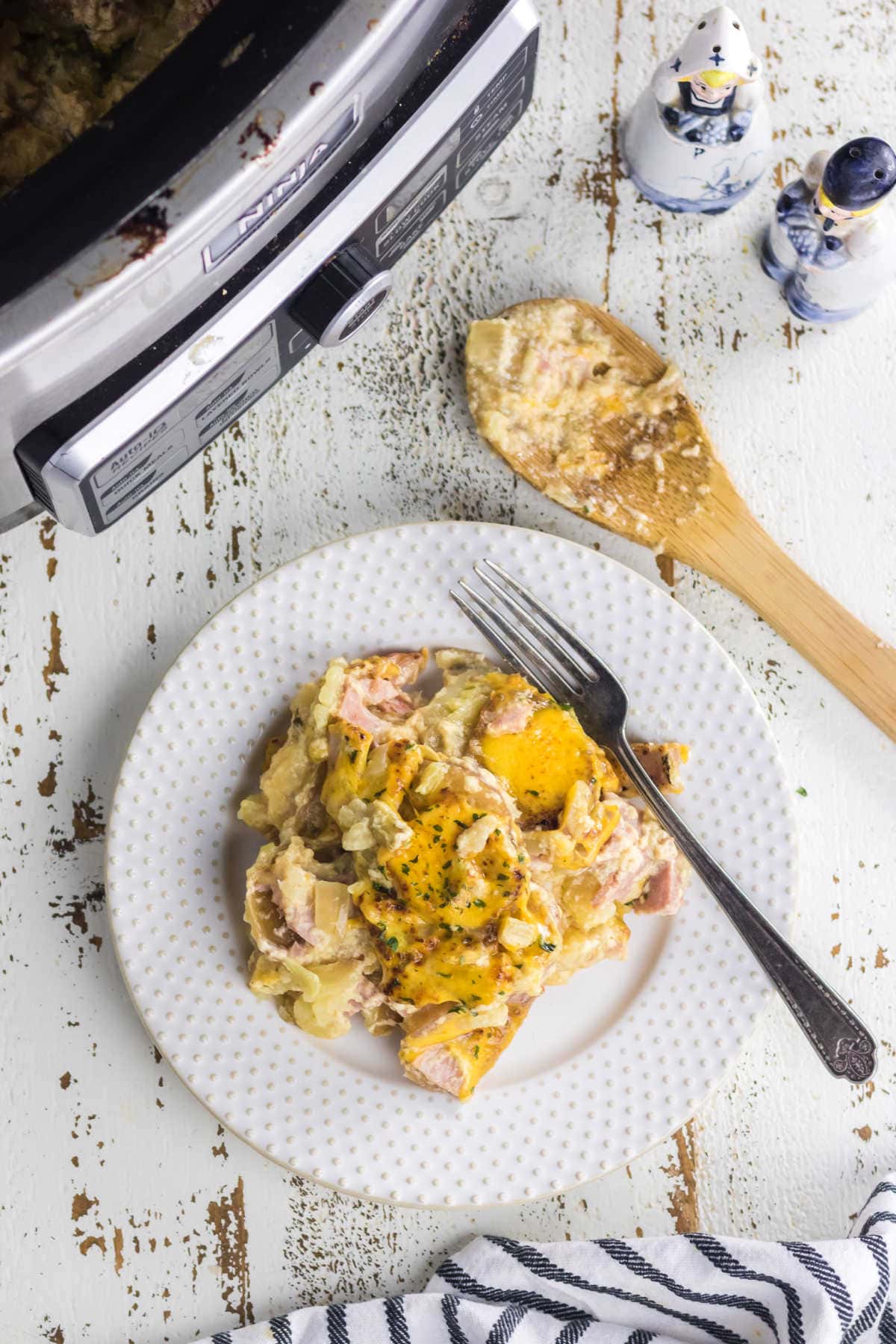 A serving of scalloped potatoes on a plate.