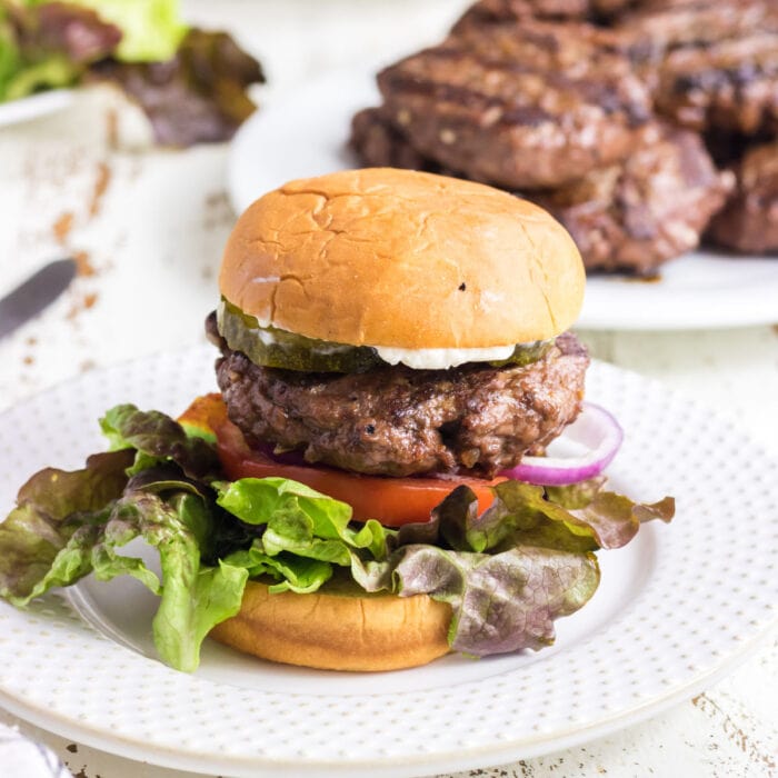 Closeup of a finished hamburger in a bun.