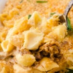 Closeup of a scoop of mac and cheese with a title text for Pinterest.