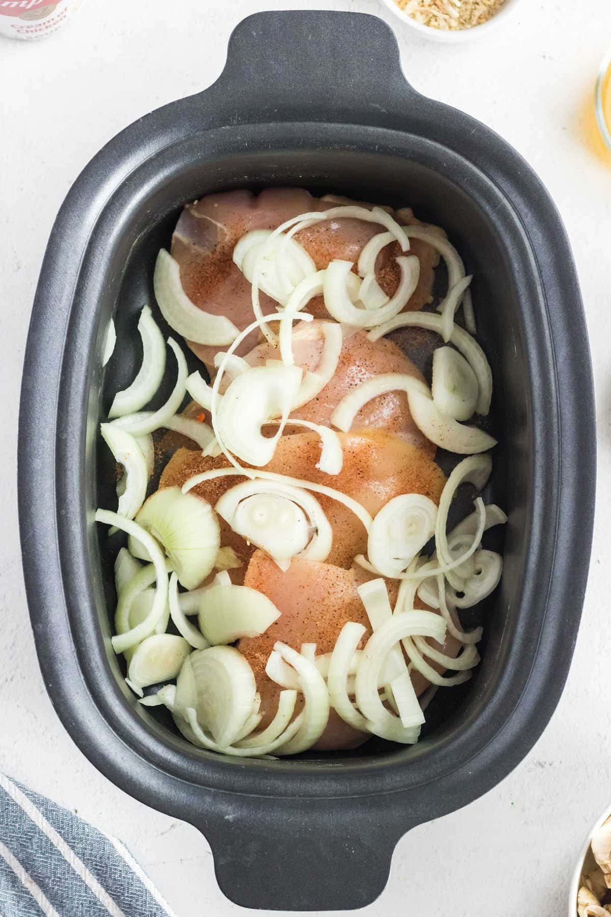 Chicken and onions in a crockpot.