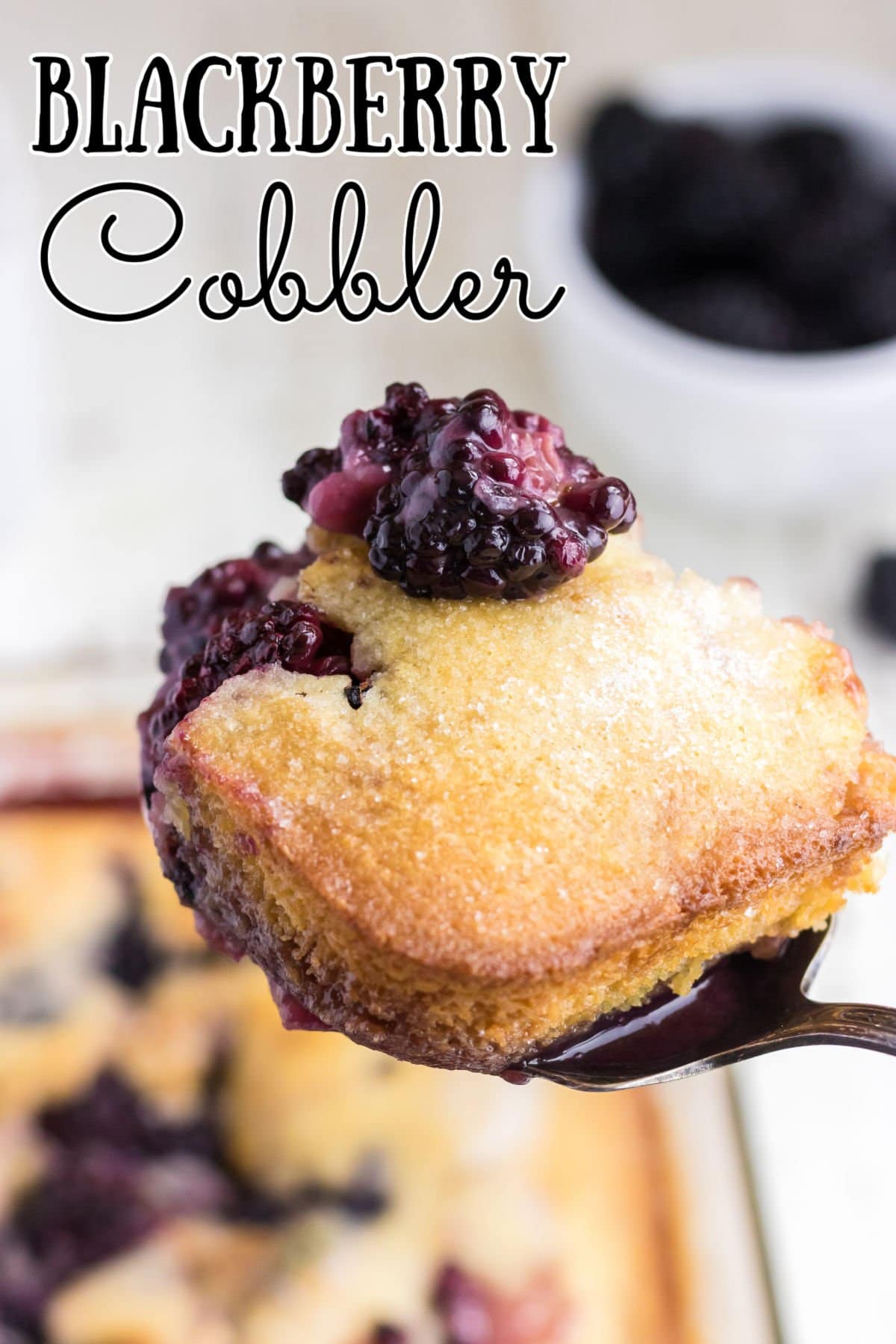 A spoonful of blackberry cobbler with a title text overlay.