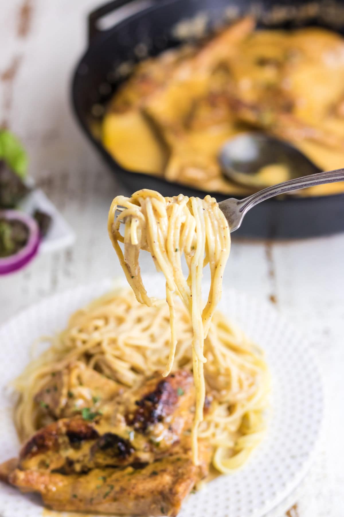 Pasta being twirled around a fork.