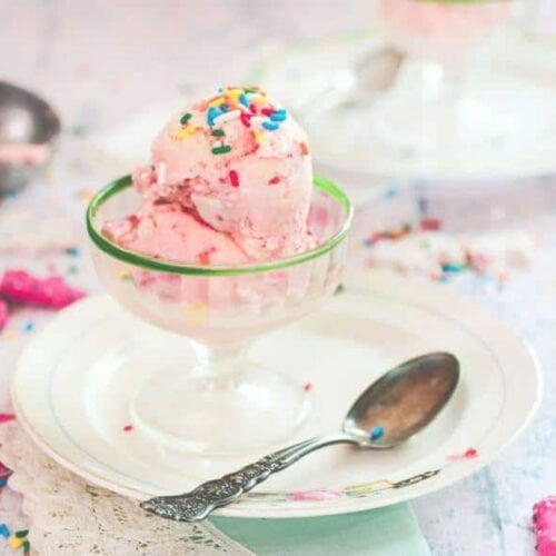 Pink ice cream in a vintage glass ice cream dish.