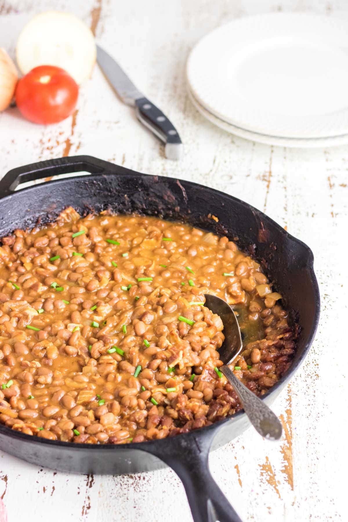 Finished baked beans in a skillet.