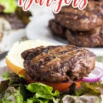 A grilled burger on a hamburger bun with title text overlay for Pinterest.