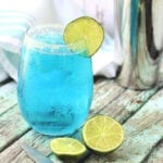 Blue cocktail with a lime garnish for feature image.