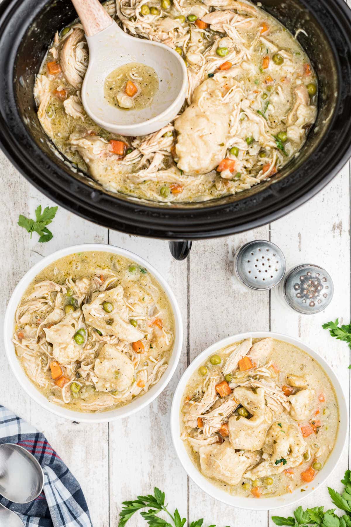 Two bowls filled with chicken and dumplings.