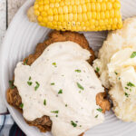 Chicken fried steak on a plate with text overlay for Pinterest.