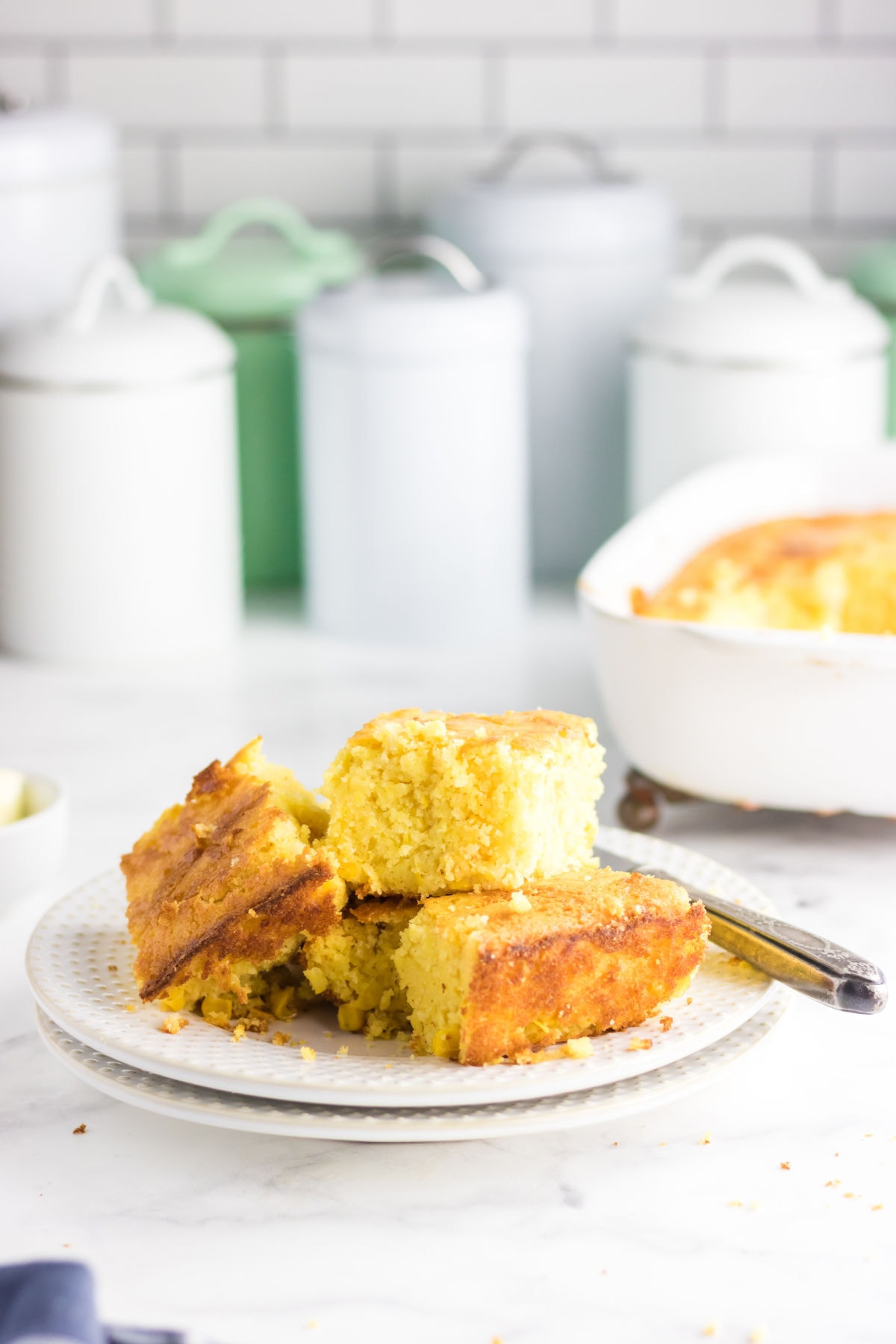 A stack of cornbread on a plate.