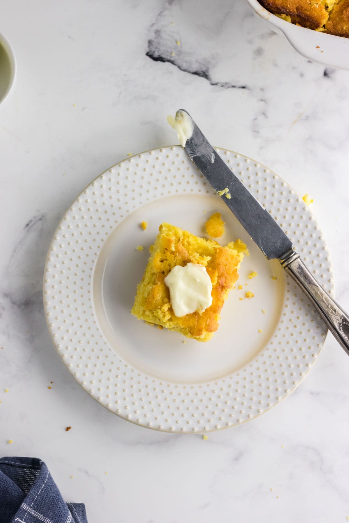 Overhead view of cornbread with butter.