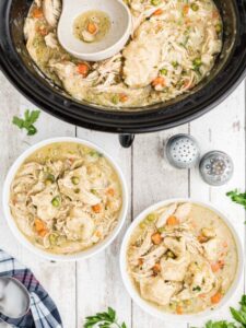 Two bowls filled with chicken and dumplings.