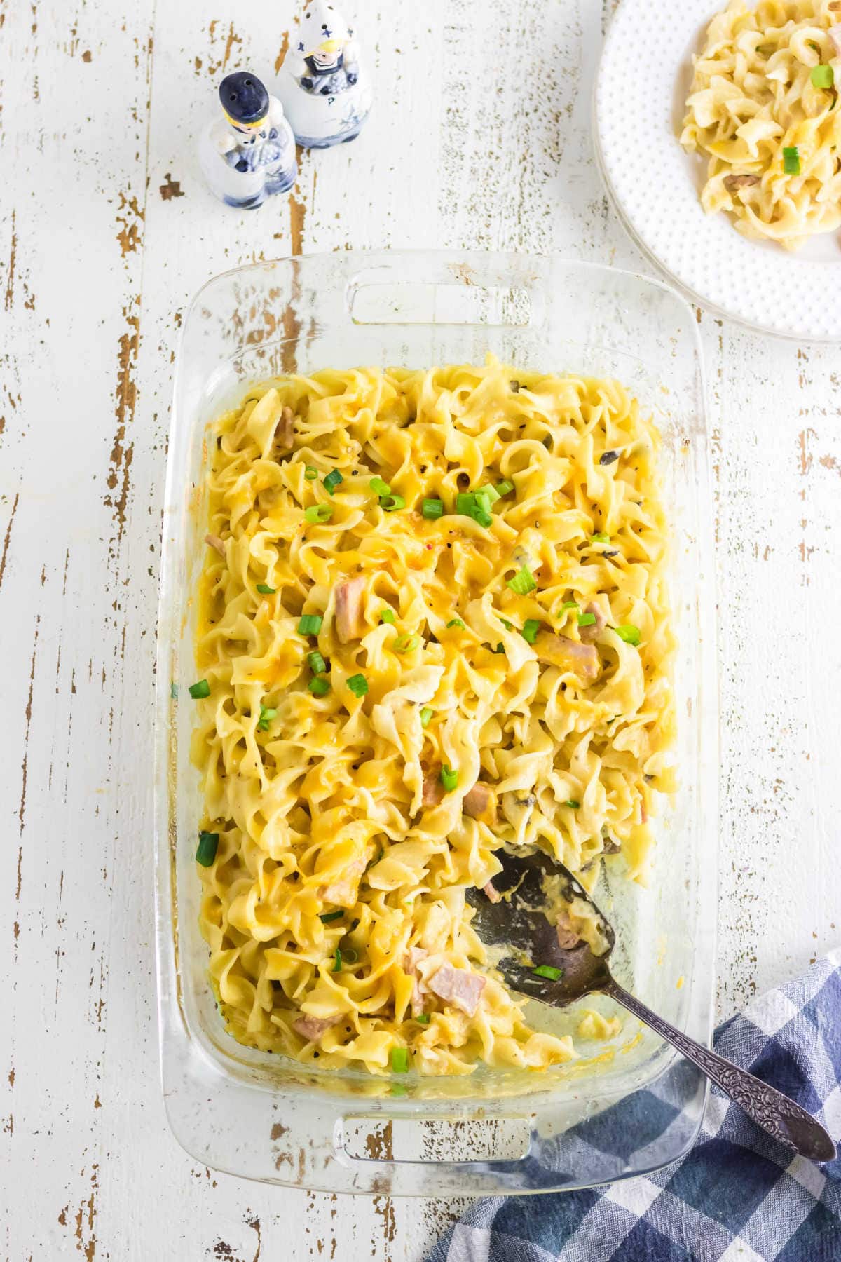 A casserole dish filled with ham and noodles.