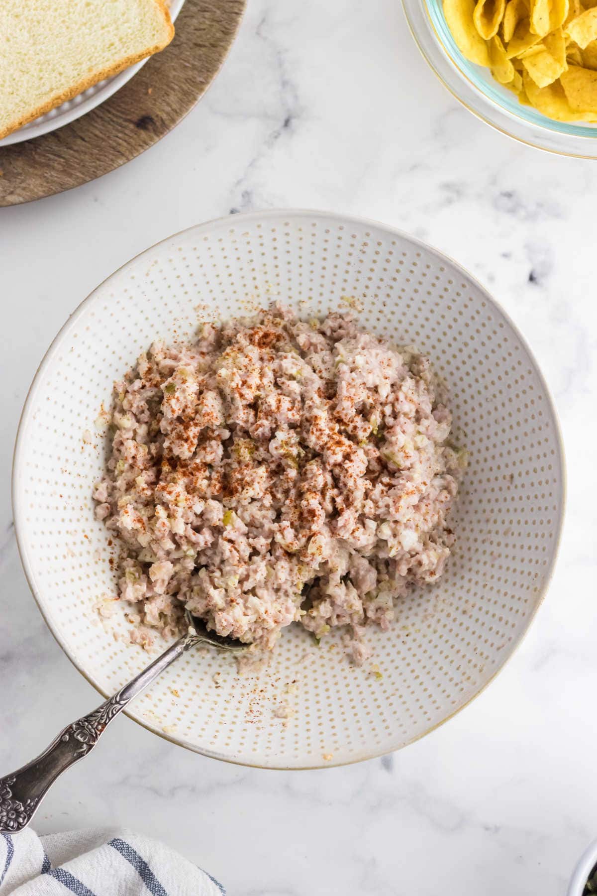 Overhead view of deviled ham salad spread in a bowl.