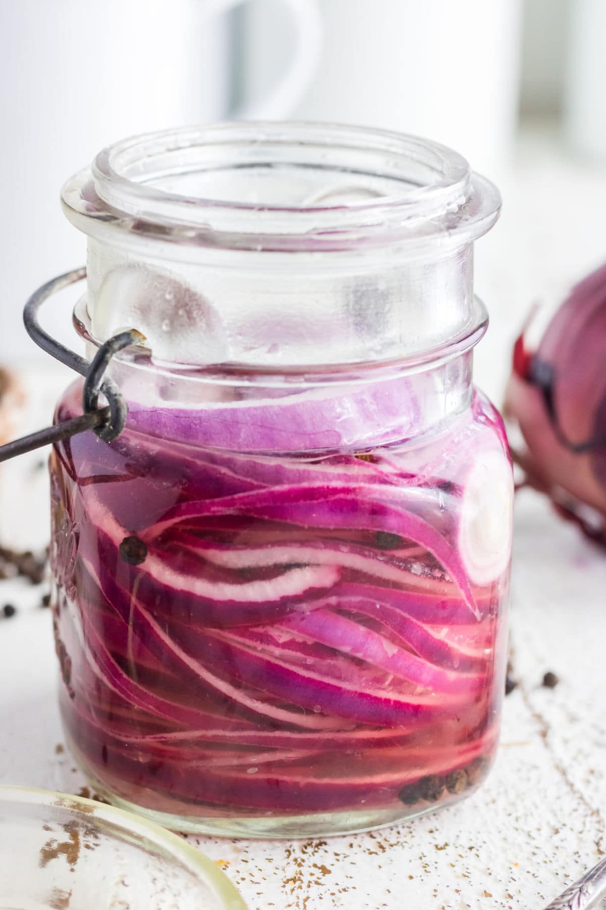 Red onions in a covered jar.