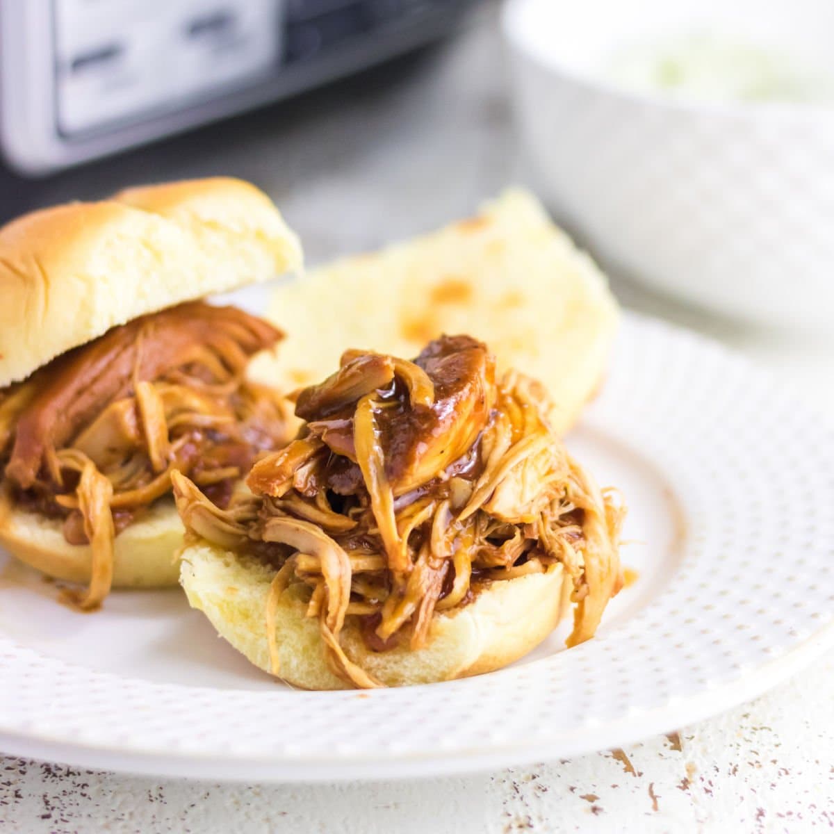 Closeup of a pulled chicken sandwich.