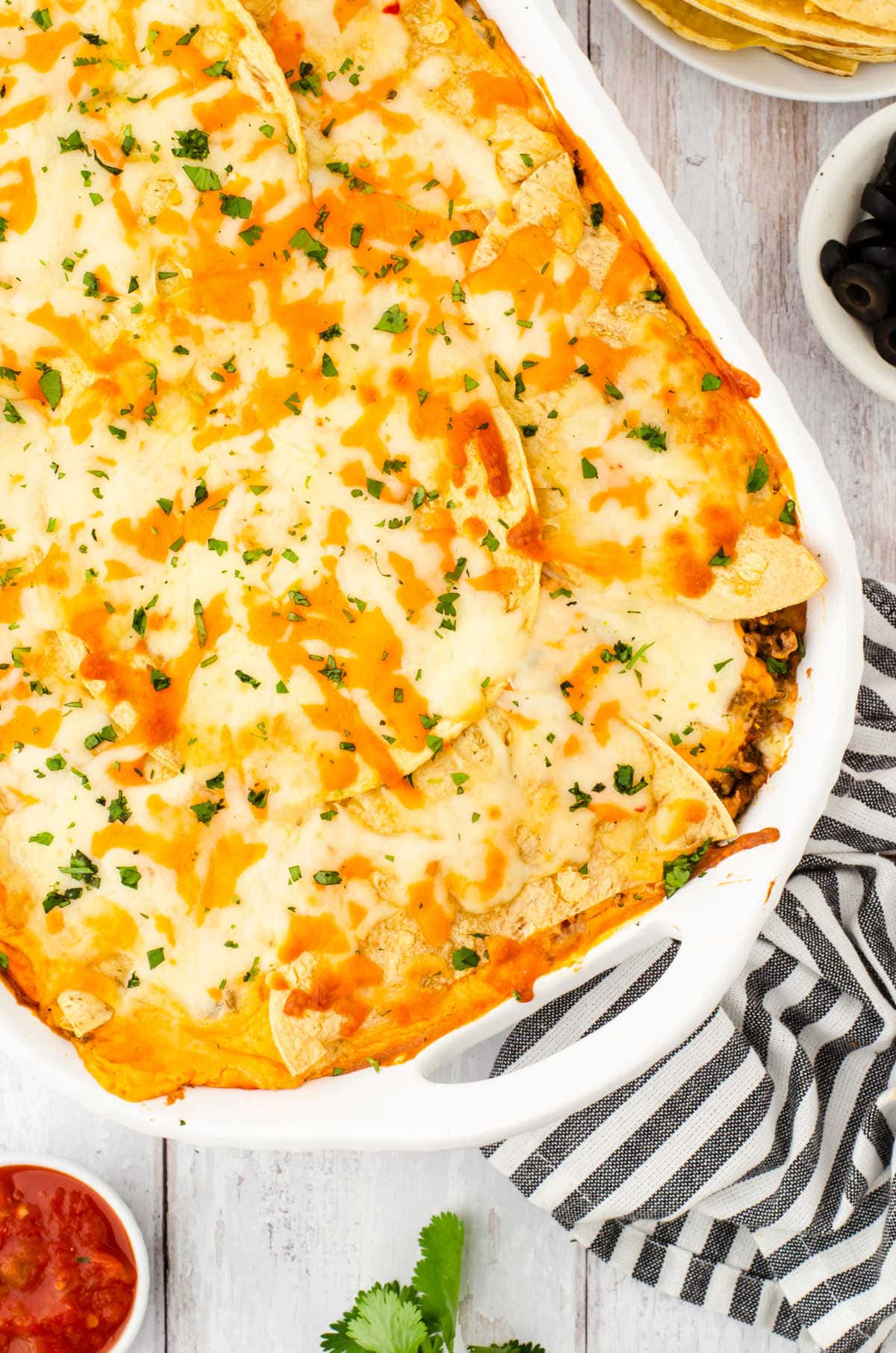 Overhead view of Mexican Lasagna in a white dish.