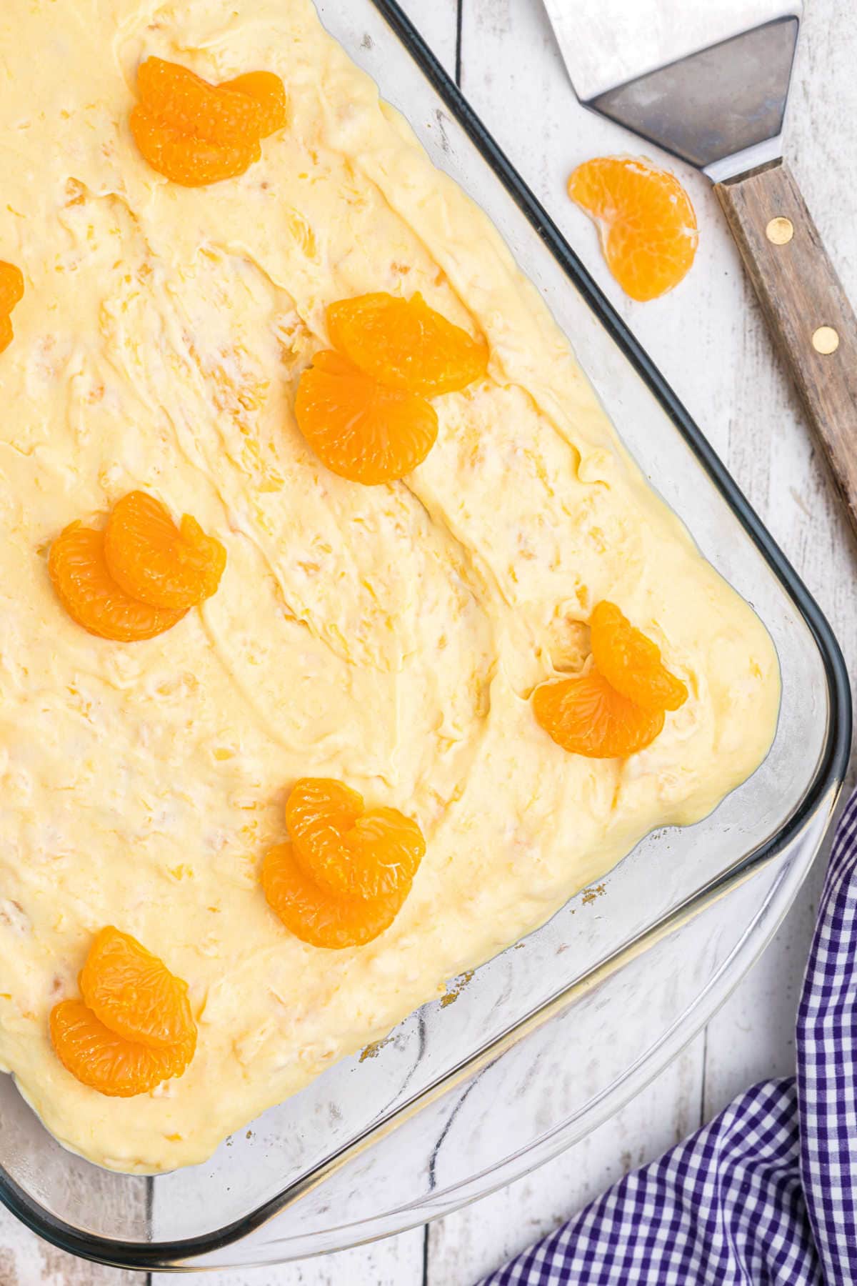 Overhead view of cake with oranges on top.