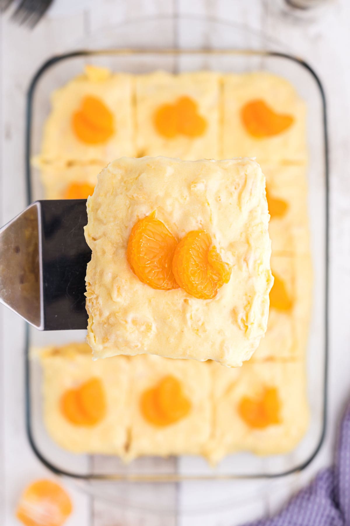 A piece of cake being removed from the pan.