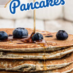 A stack of blueberry blue cornmeal pancakes with syrup and a text overlay for Pinterest.