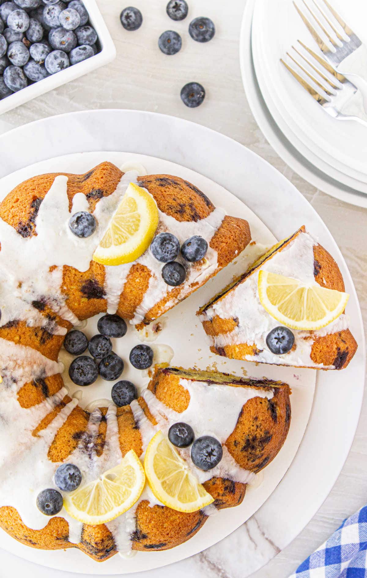 Overhead view of cake with a slice being removed.