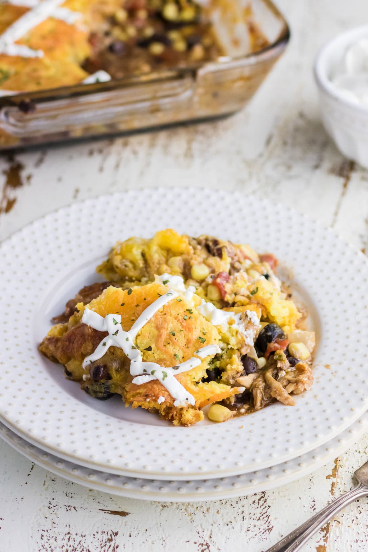 A dish with a serving of pulled pork tamale pie in it.