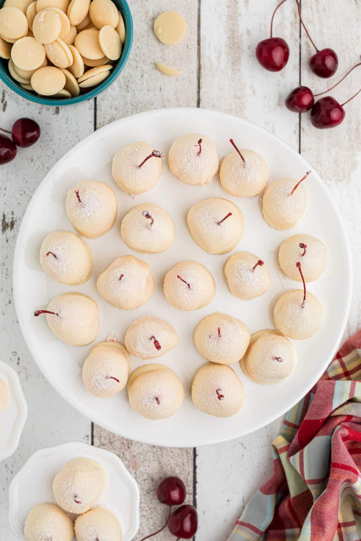 Overhead view of cherries on a cake plate.