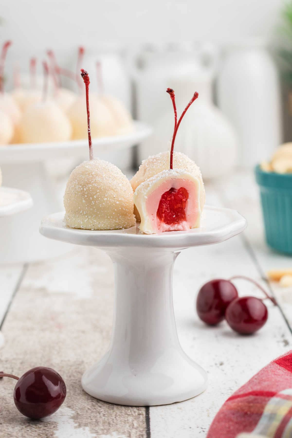 White chocolate covered cherries on a white cakeplate.
