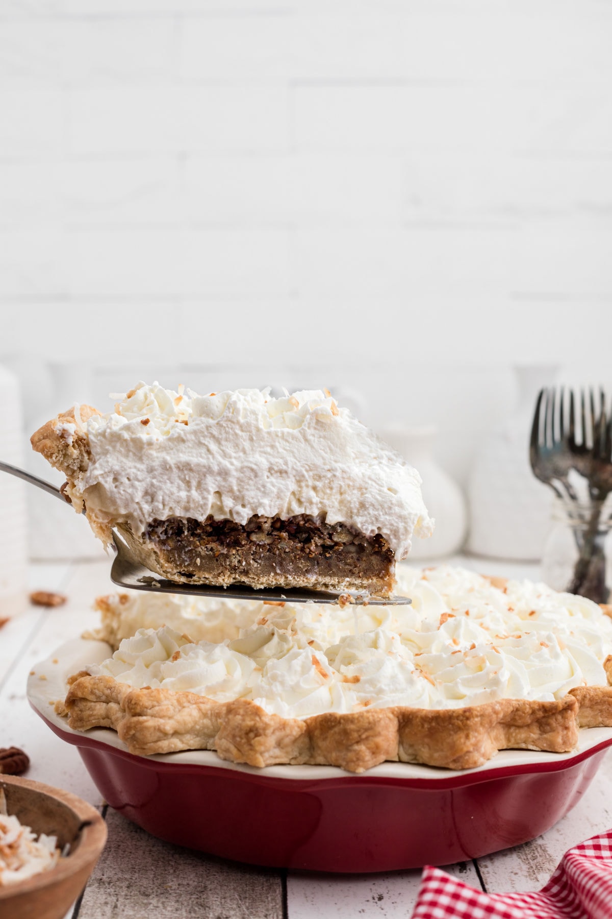 A slice of pie being removed from dish.