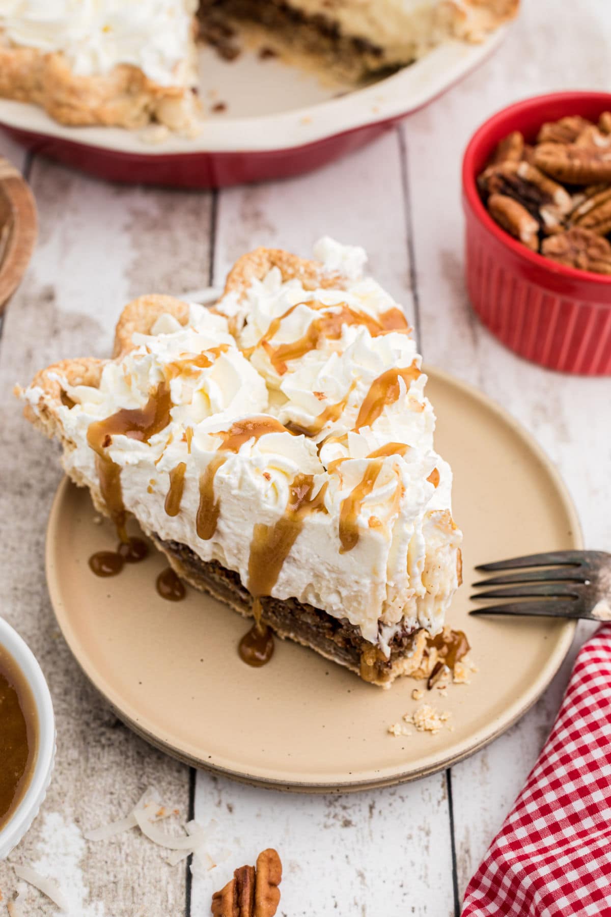 A slice of pie with whipped cream topping.