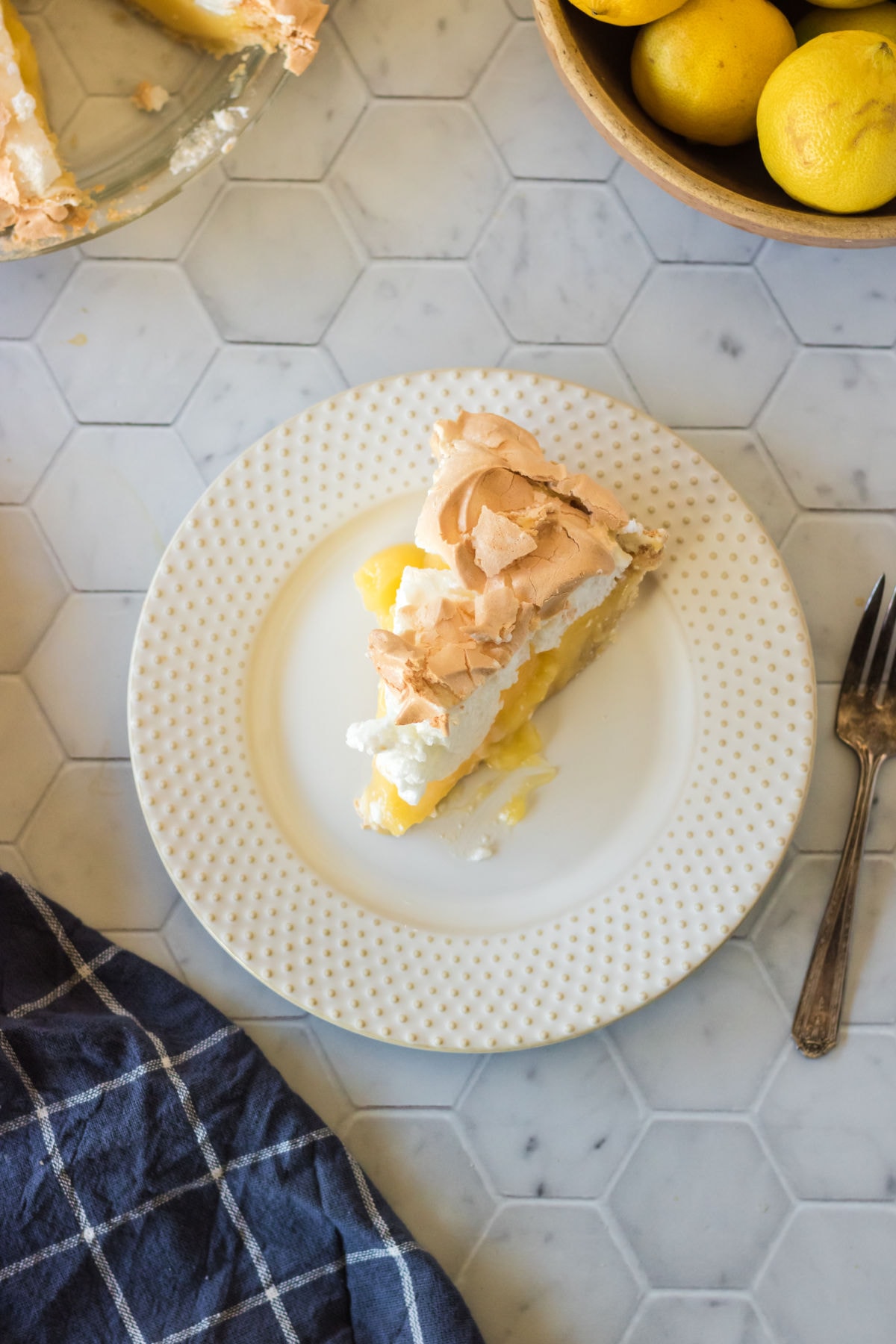 Overhead view of a slice of lemon meringue pie.