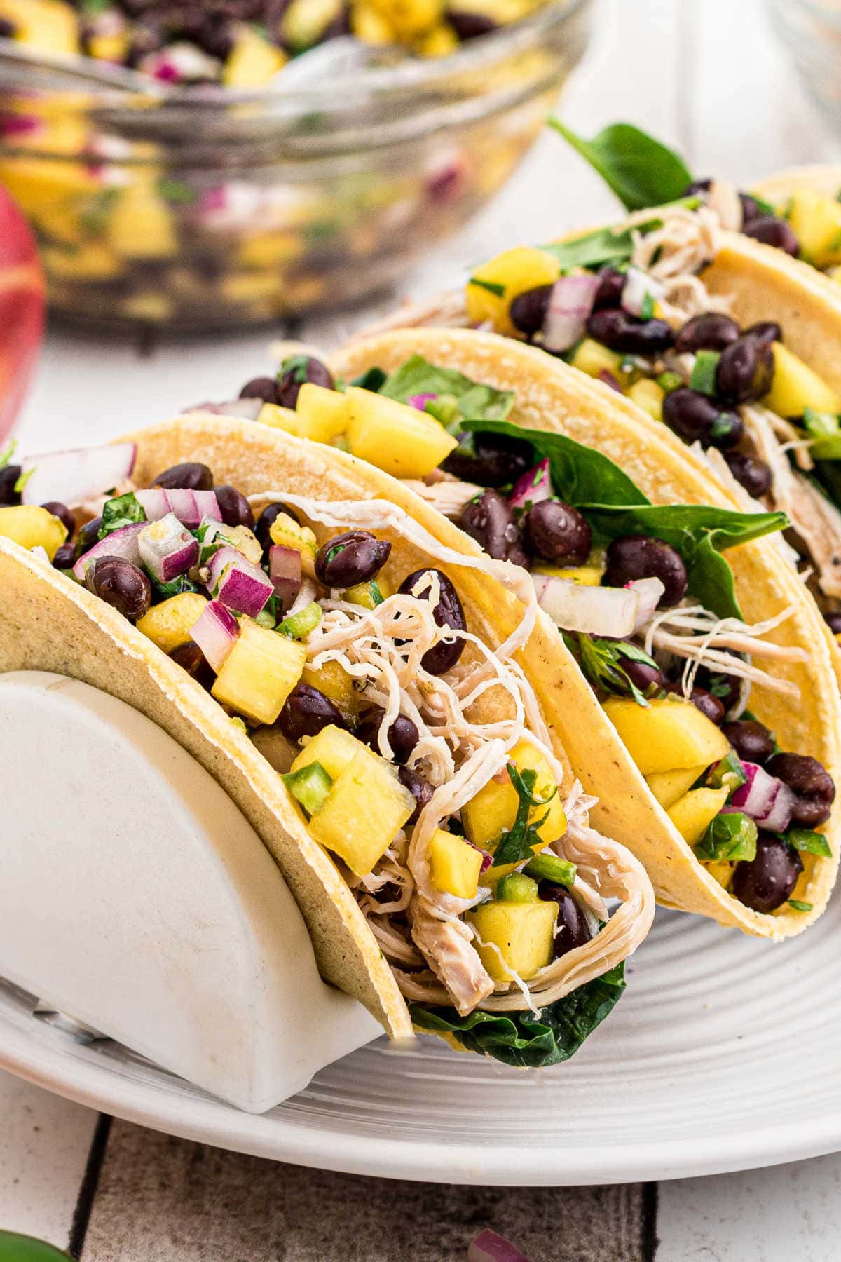 Tacos on a white serving dish.