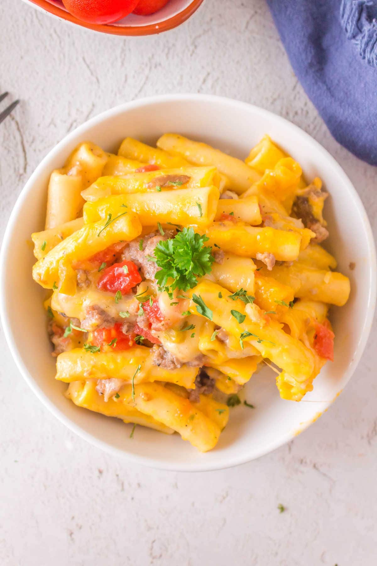 Bowl of ziti and sausage on the table.