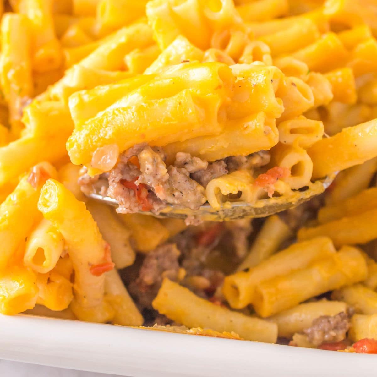 Pasta being served from the dish for featured image.