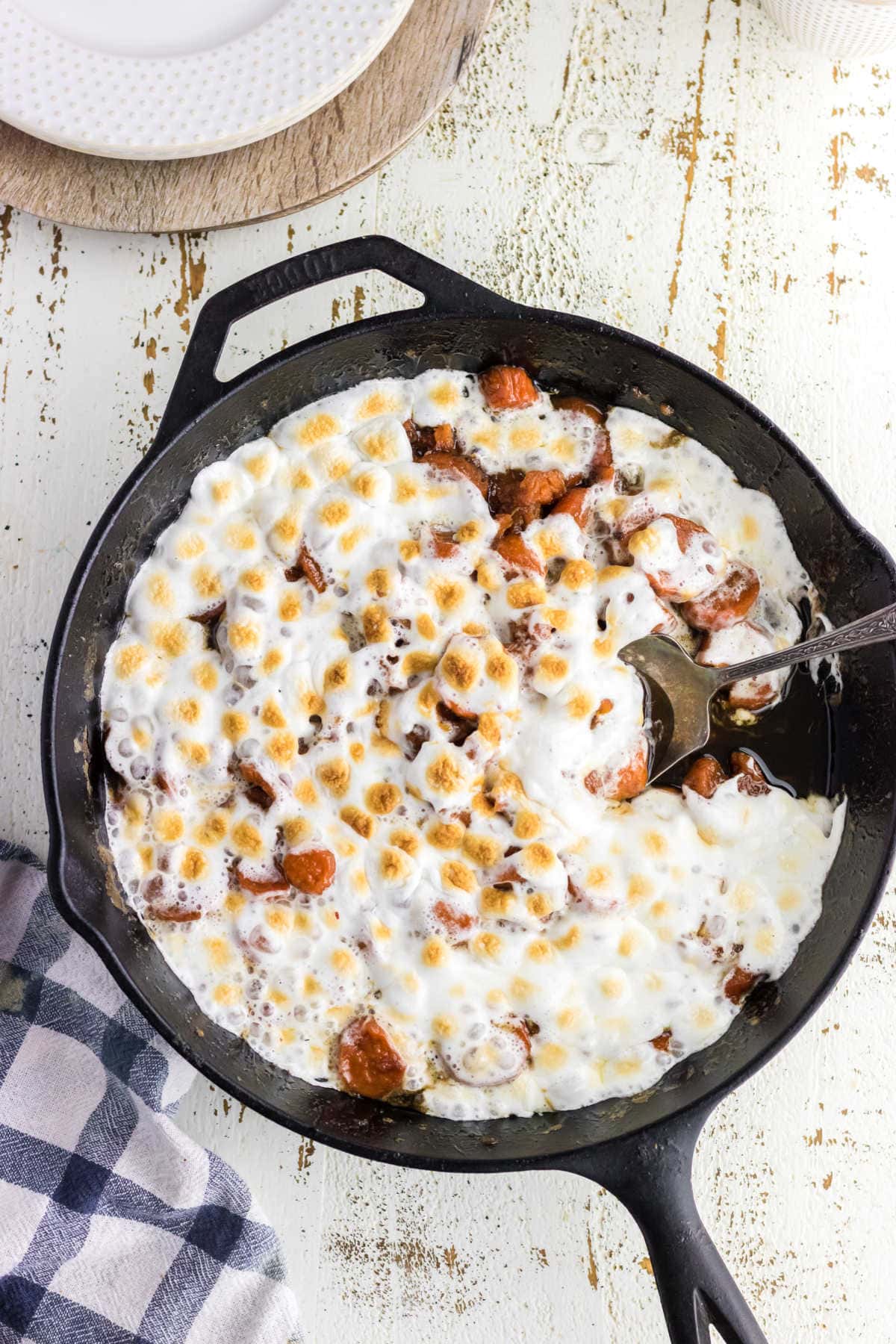 Overhead view of a skillet with candied yams in it.