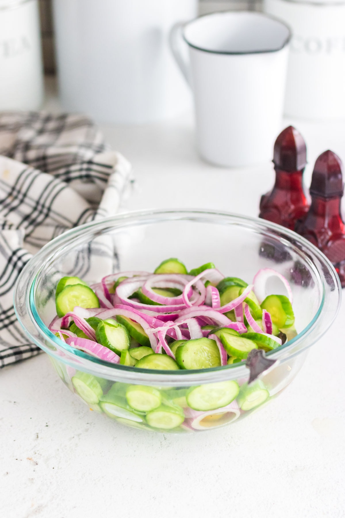 A bowl of southern cucumber salad on a table.