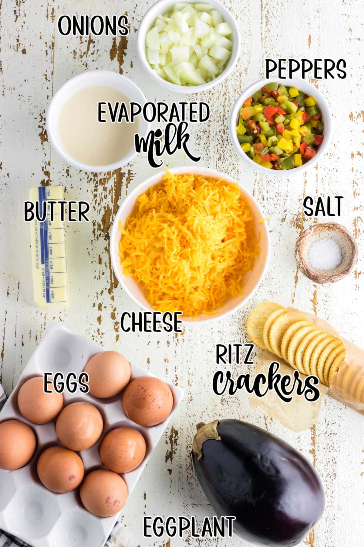 Labeled ingredients for the eggplant casserole on a wooden background.